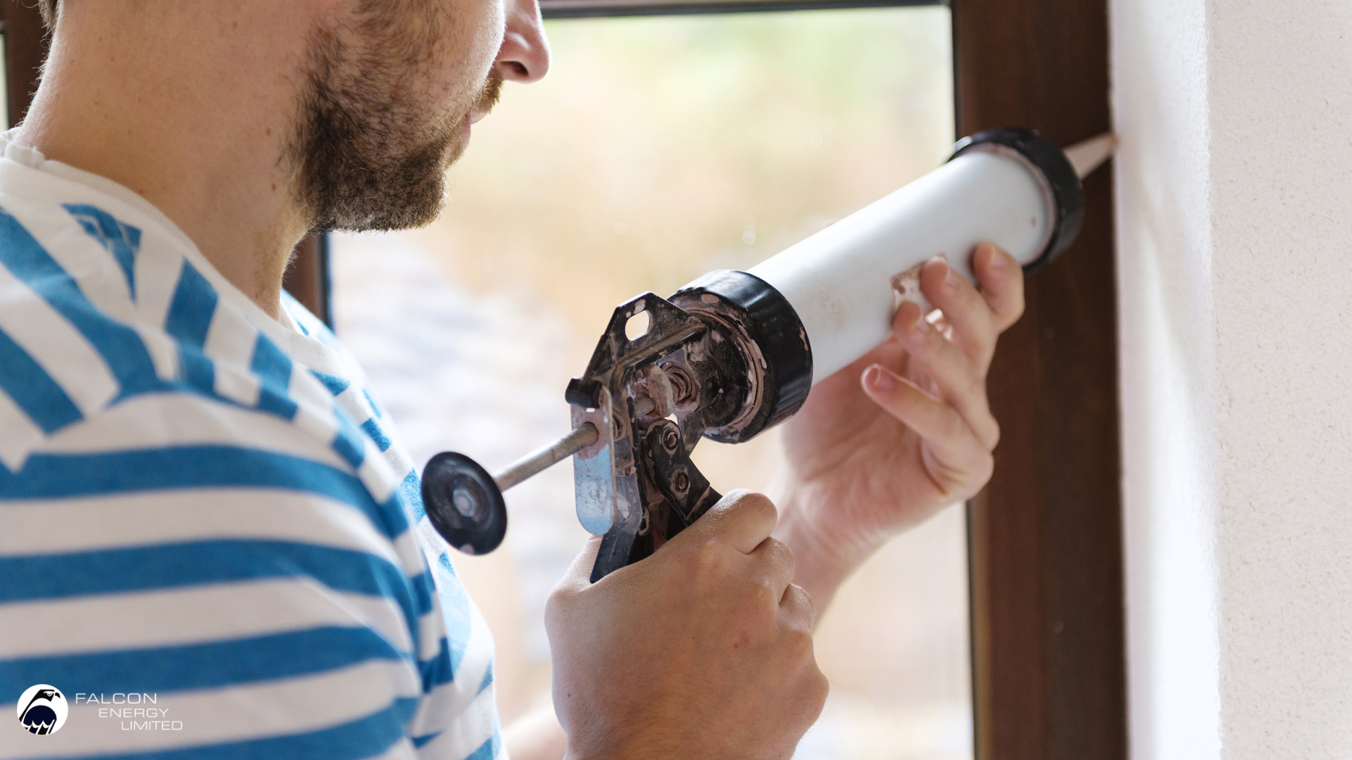 Man caulking window