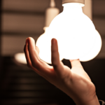 image of hand screwing in a lightbulb