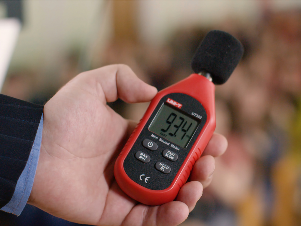 hand holding a sound level meter