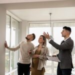 a couple viewing a house with an estate agent