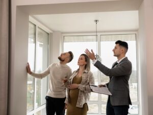 a couple viewing a house with an estate agent
