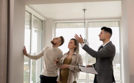 a couple viewing a house with an estate agent